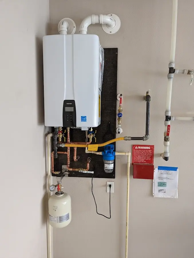 Professional plumber installing copper piping in a Dennis home